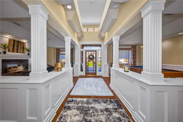 a view of a hallway with furniture and a rug