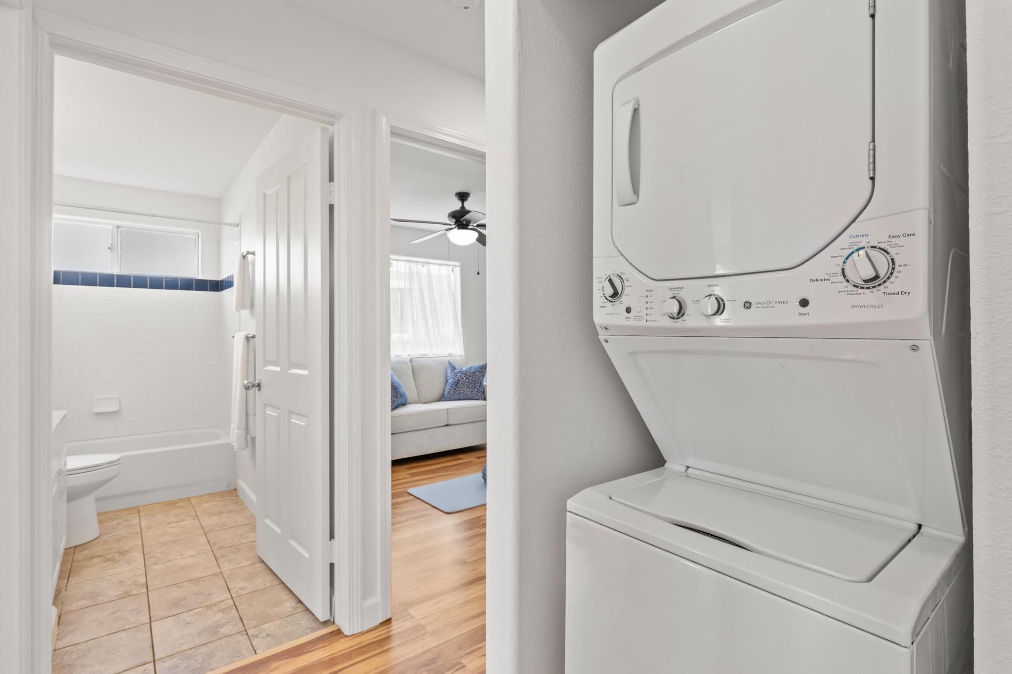 75-6081 Alii Drive, Unit V106 Kailua-Kona, HI 96740 - Photo 12 of 25 hallway with wooden door washer and dryer