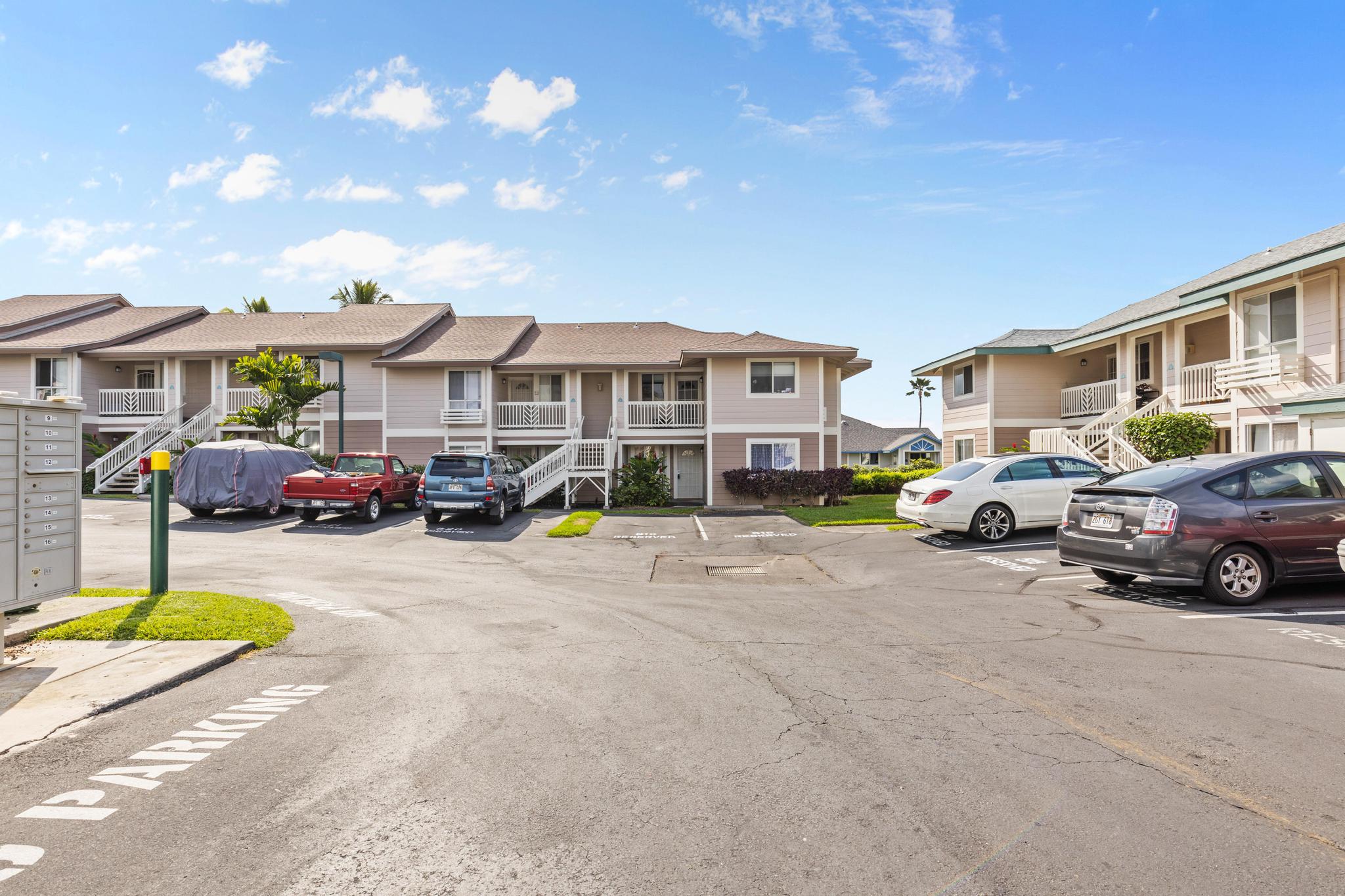 75-6081 Alii Drive, Unit V106 Kailua-Kona, HI 96740 - Photo 17 of 25 a view of a cars parked in front of a house