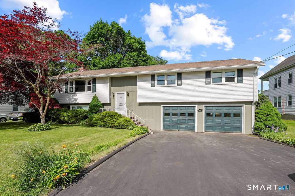 142 Wolcott Hill Road Wethersfield, CT 06109 - Photo 2 of 29 front view of a house with a yard