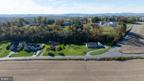 an aerial view of a house with a yard and lake view
