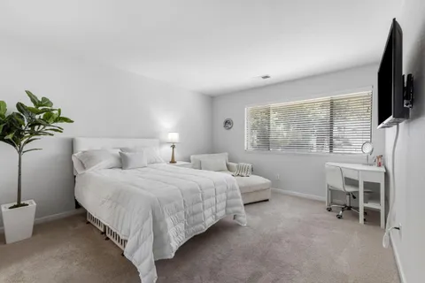 a bedroom with a bed and a flat screen tv