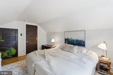 a bedroom with a bed and a lamp