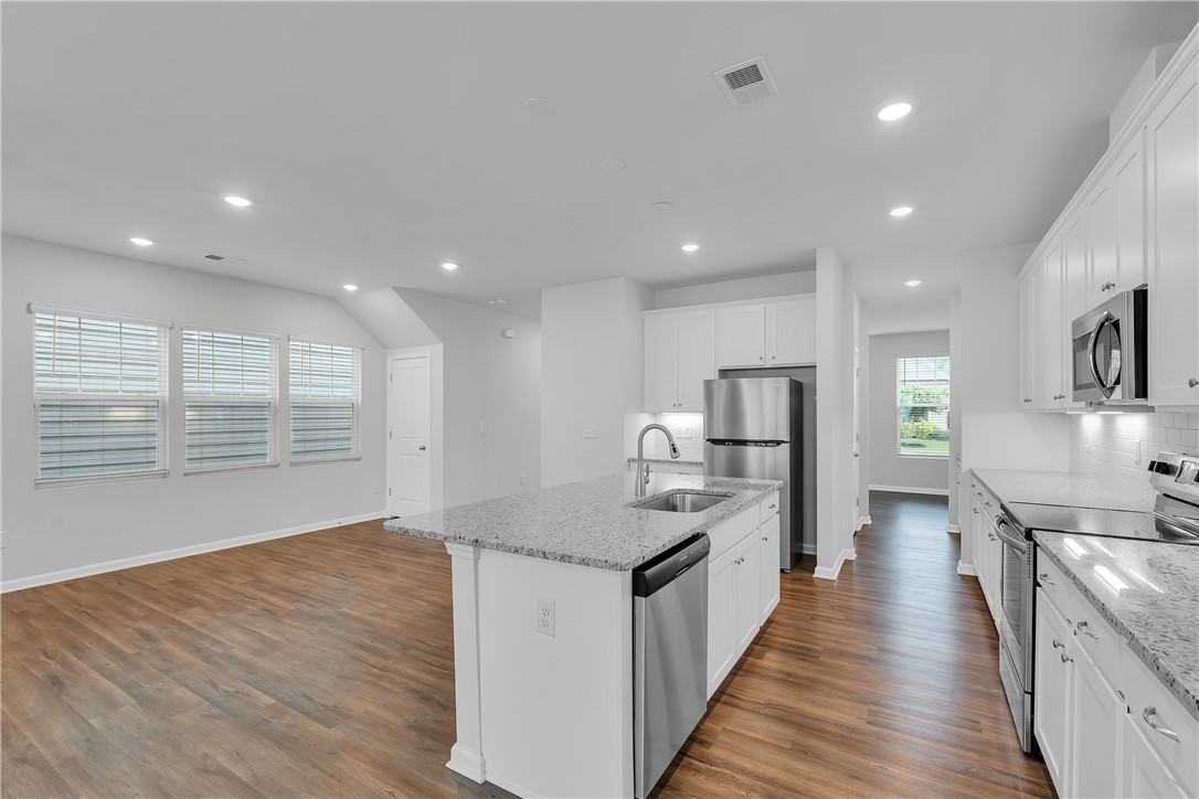 8 Leander Drive Greer, SC 29651 - Photo 8 of 31 A contemporary kitchen featuring stainless steel appliances and an inviting island with a sink.