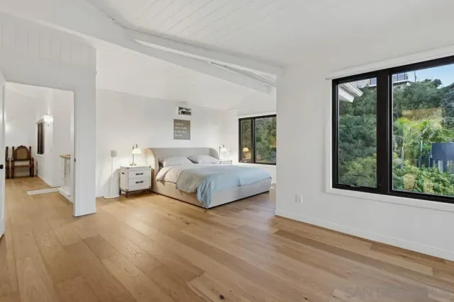 a bedroom with a bed and a large window