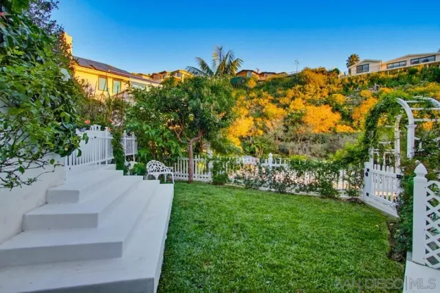 a view of a garden with a building in the background