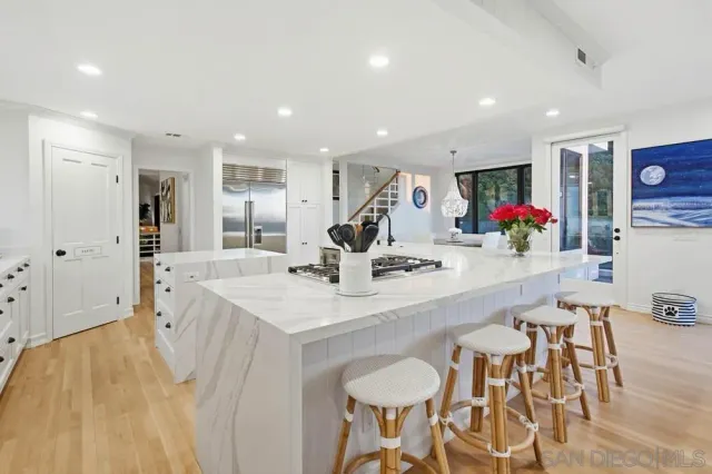 a large kitchen with a table and chairs