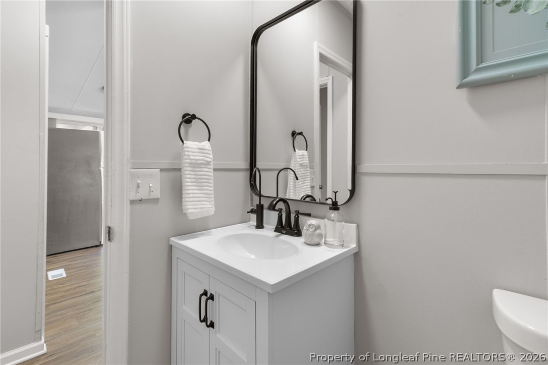6568 Sandy Creek Road Stedman, NC 28391 - Photo 21 of 34 a bathroom with a sink and a mirror