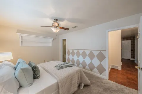 a bedroom with a bed and a chandelier