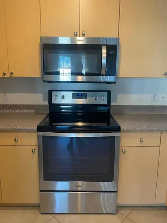 a stove top oven sitting inside of a kitchen
