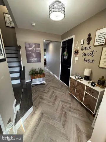 a view of a livingroom with furniture and staircase