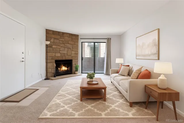 a living room with furniture and a fireplace