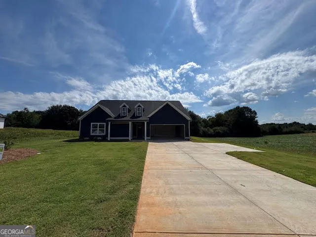 a view of a big house with a big yard and a large trees