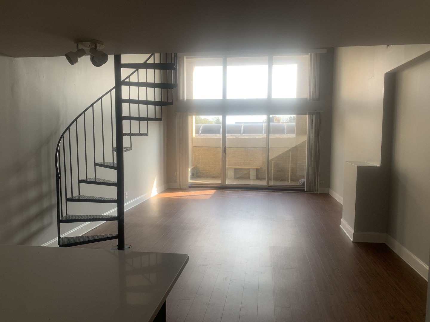 925 Green Bay Road, Unit 18 Winnetka, IL 60093 - Photo 3 of 10 an empty room with windows and stairs