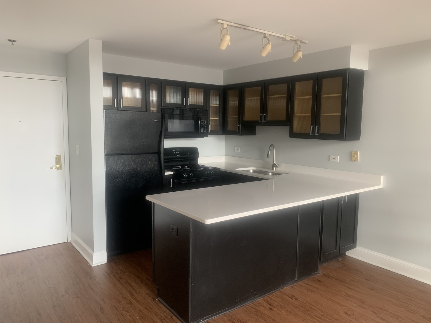 925 Green Bay Road, Unit 18 Winnetka, IL 60093 - Photo 7 of 10 a kitchen with stainless steel appliances granite countertop a sink and a refrigerator