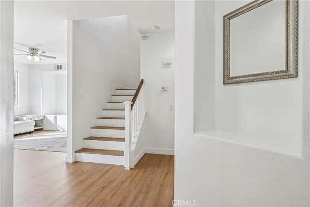 a view of a hallway with wooden floor and entryway