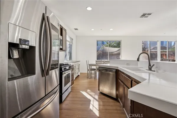 a kitchen with stainless steel appliances a sink and a refrigerator