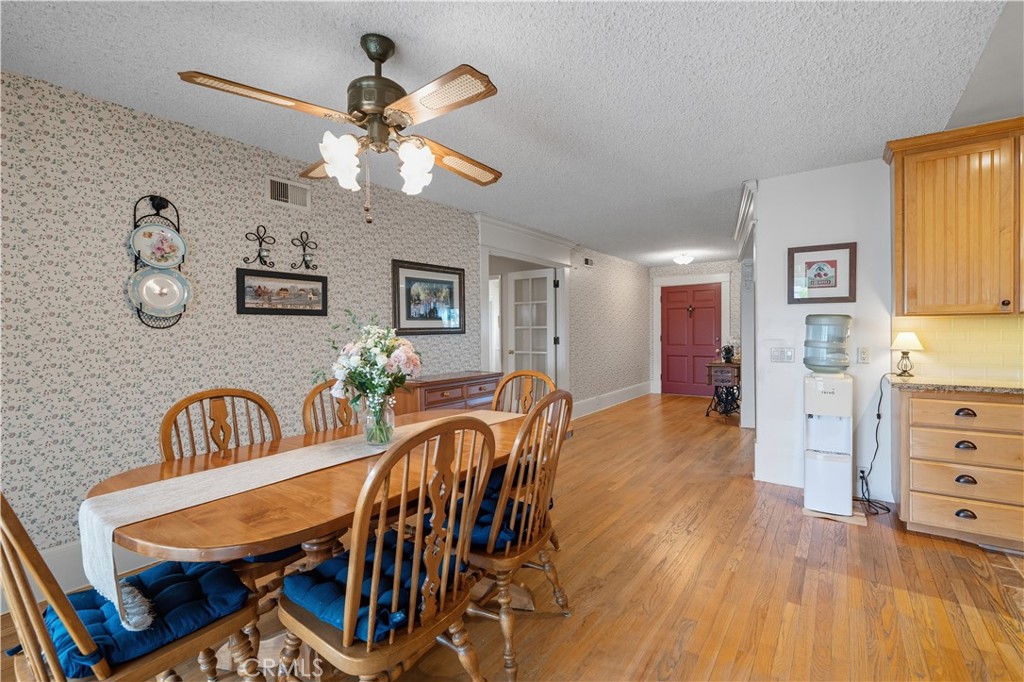1181 Gearald Way Fallbrook, CA 92028 - Photo 11 of 39 a dining room with furniture a chandelier and wooden floor