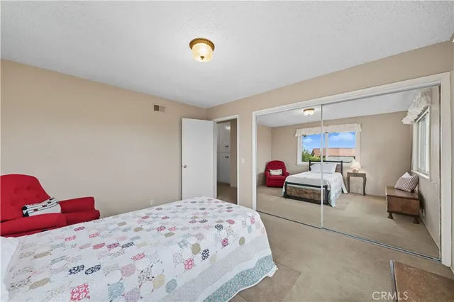 a bedroom with a bed and a couch