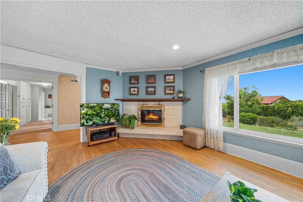 1181 Gearald Way Fallbrook, CA 92028 - Photo 7 of 39 a living room with furniture and a fireplace