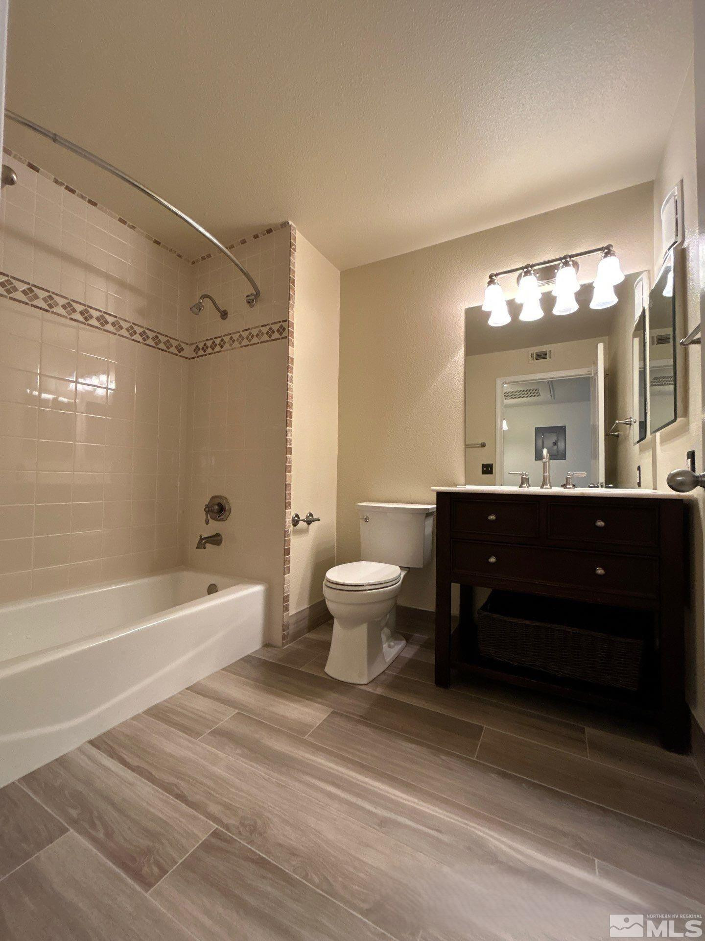 6850 Sharlands Avenue, Unit AB2170 Reno, NV 89523 - Photo 14 of 16 a bathroom with a sink a toilet a mirror and bathtub