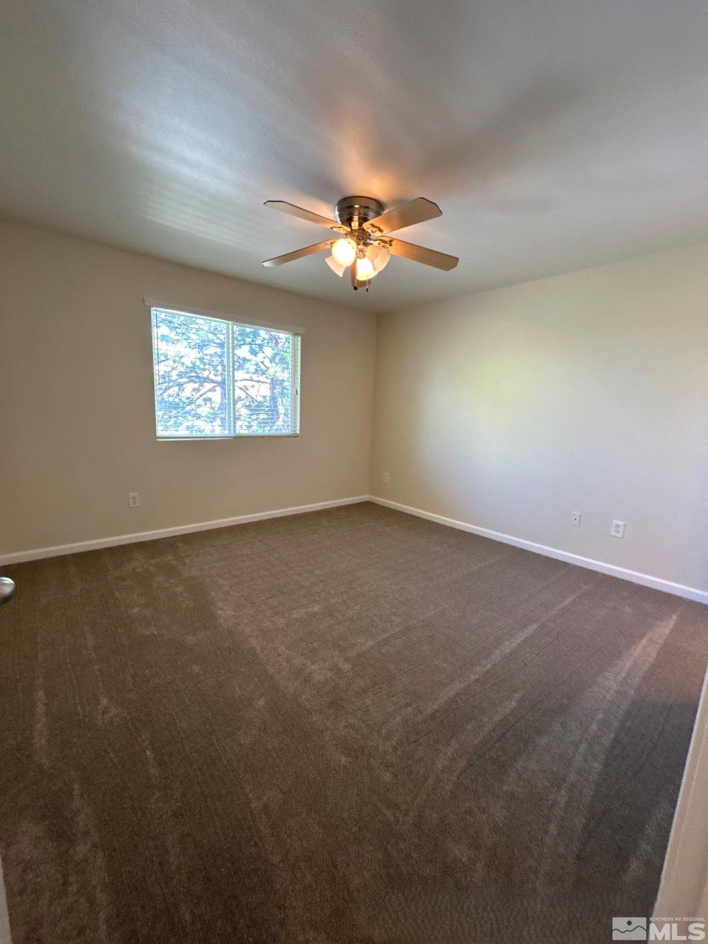 6850 Sharlands Avenue, Unit AB2170 Reno, NV 89523 - Photo 16 of 16 an empty room with a ceiling fan and a window