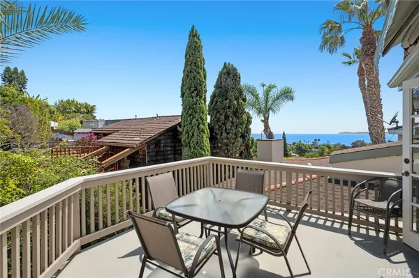 a view of a patio with couches table and chairs and potted plants