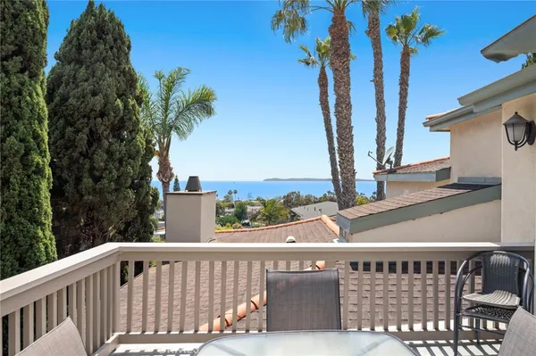 a kitchen with granite countertop a refrigerator a sink a stove a kitchen island and cabinets