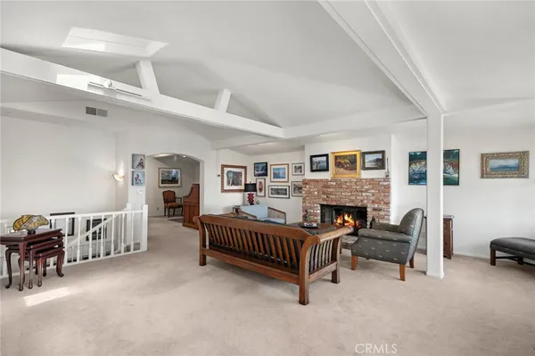 a living room with furniture fireplace and window