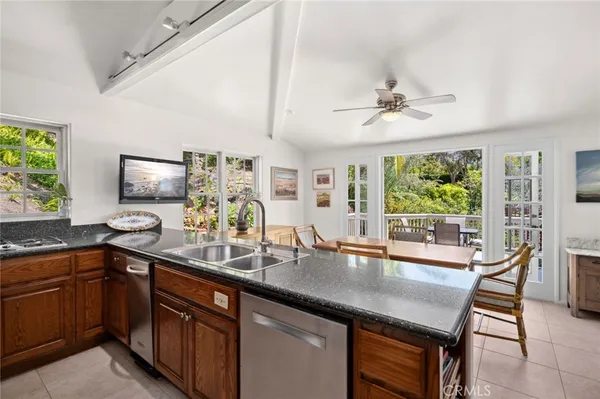 a kitchen with a sink and large windows