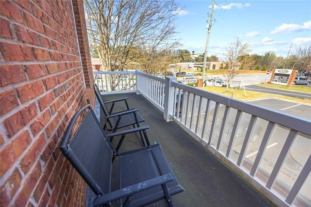 3440 Blue Springs Road, Unit 103 Kennesaw, GA 30144 - Photo 11 of 12 a view of a balcony with wooden chairs