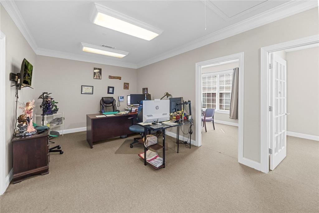 3440 Blue Springs Road, Unit 103 Kennesaw, GA 30144 - Photo 3 of 12 a view of a livingroom with furniture and a window