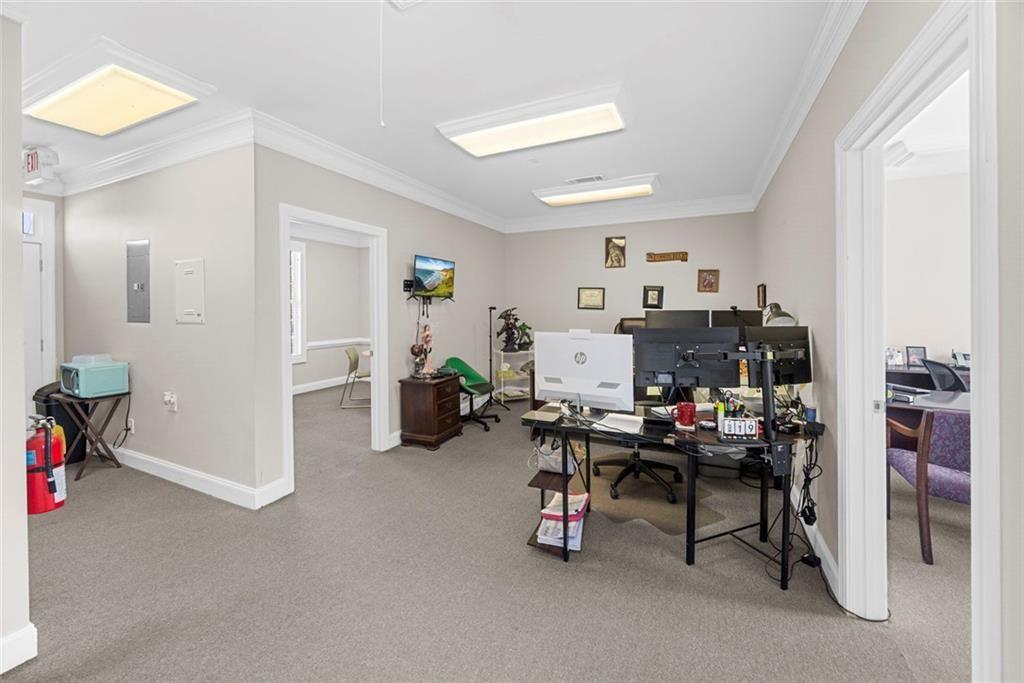 3440 Blue Springs Road, Unit 103 Kennesaw, GA 30144 - Photo 4 of 12 a view of a workspace with furniture and a livingroom