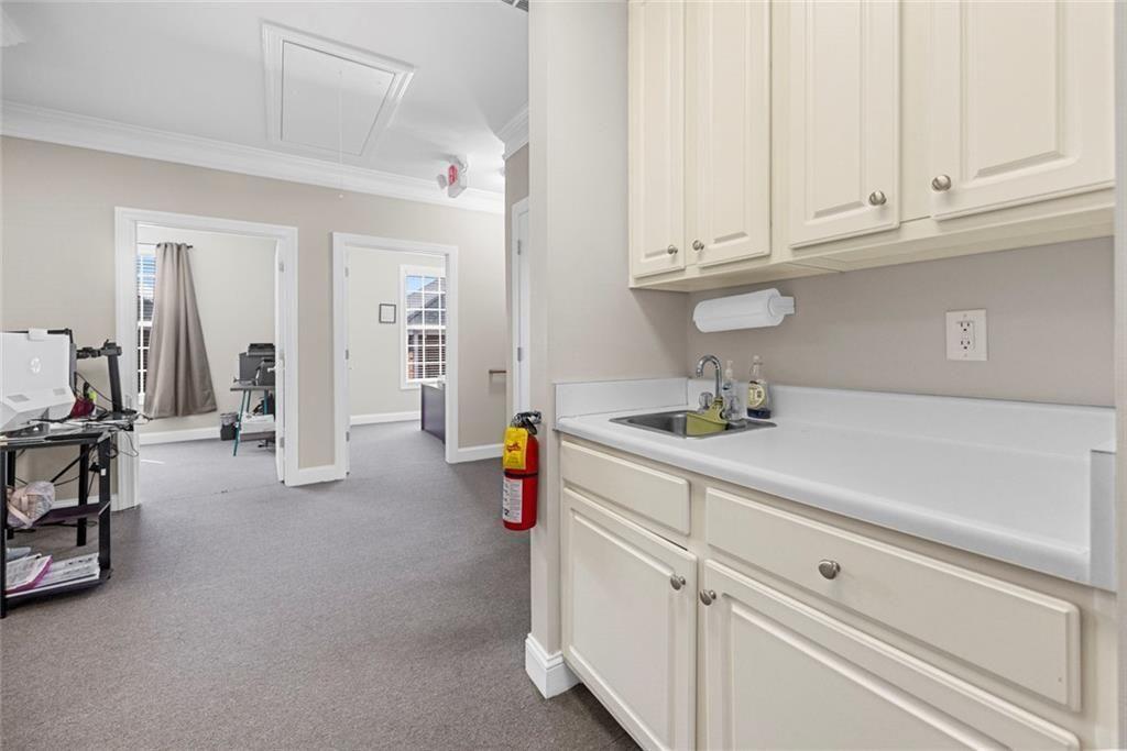 3440 Blue Springs Road, Unit 103 Kennesaw, GA 30144 - Photo 5 of 12 a kitchen with cabinets and sink