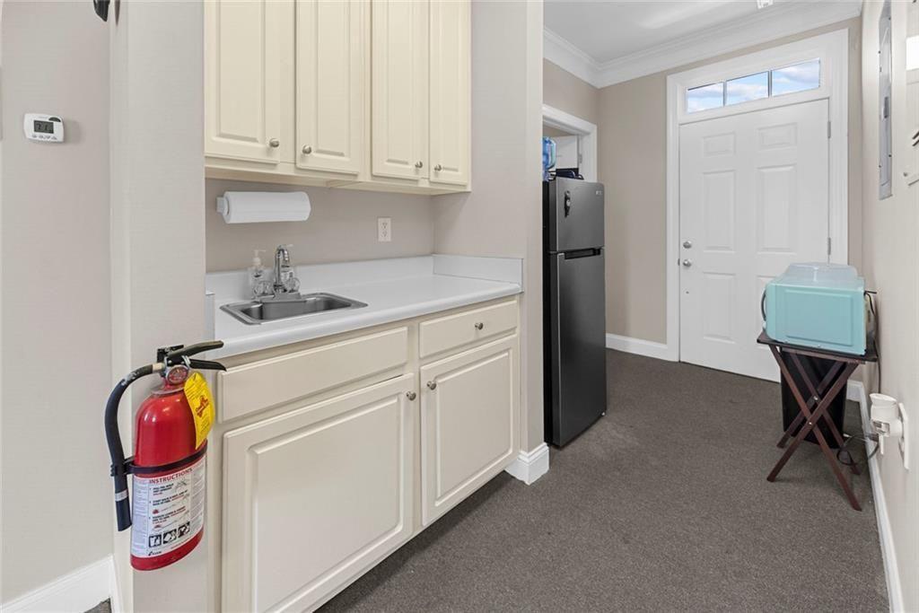 3440 Blue Springs Road, Unit 103 Kennesaw, GA 30144 - Photo 6 of 12 a utility room with fridge and workspace