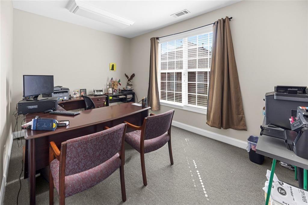 3440 Blue Springs Road, Unit 103 Kennesaw, GA 30144 - Photo 7 of 12 a room with furniture and a window