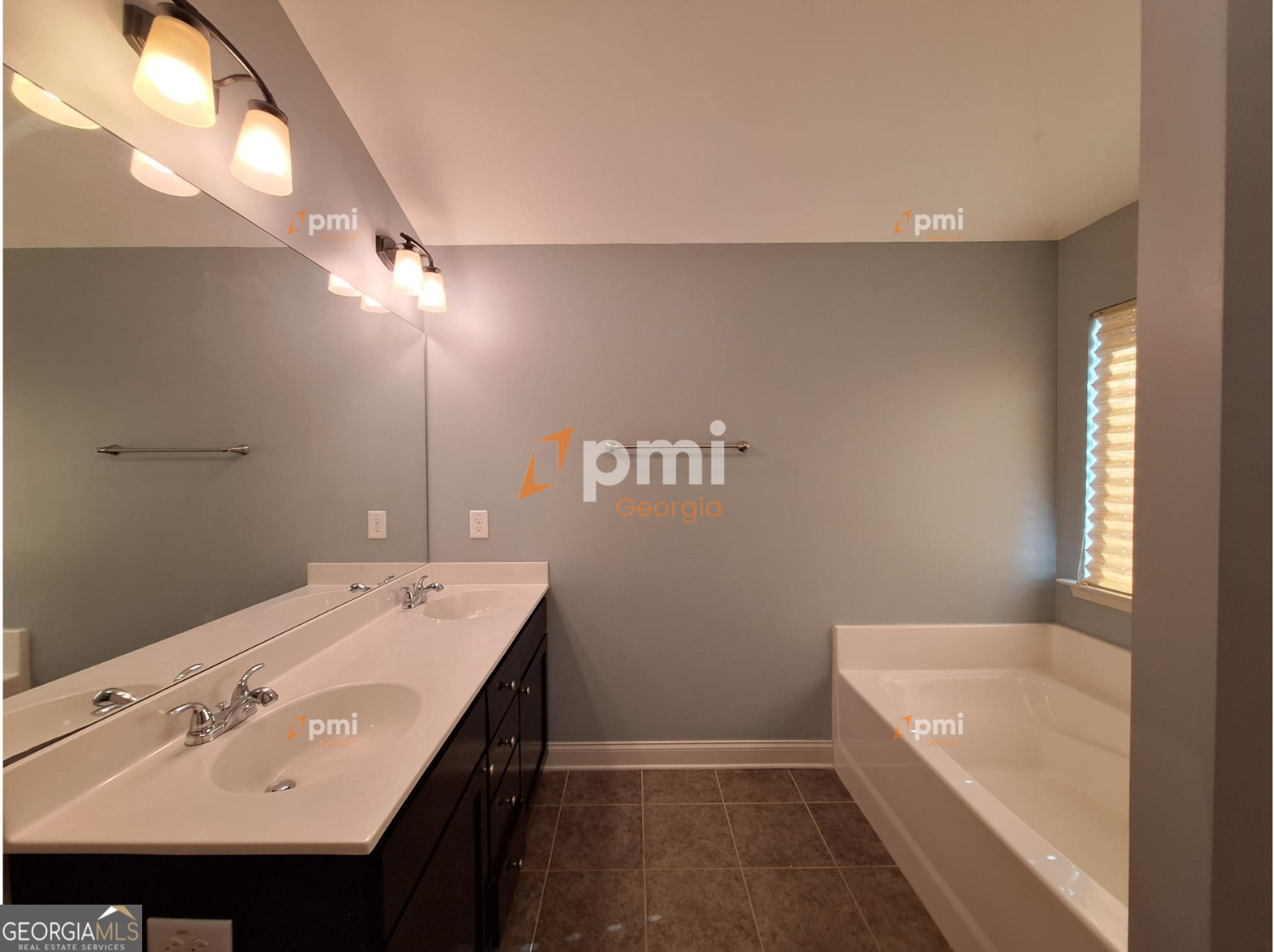 2449 Boulder Road Southeast Atlanta, GA 30316 - Photo 17 of 21 a bathroom with a sink a large mirror and a bathtub