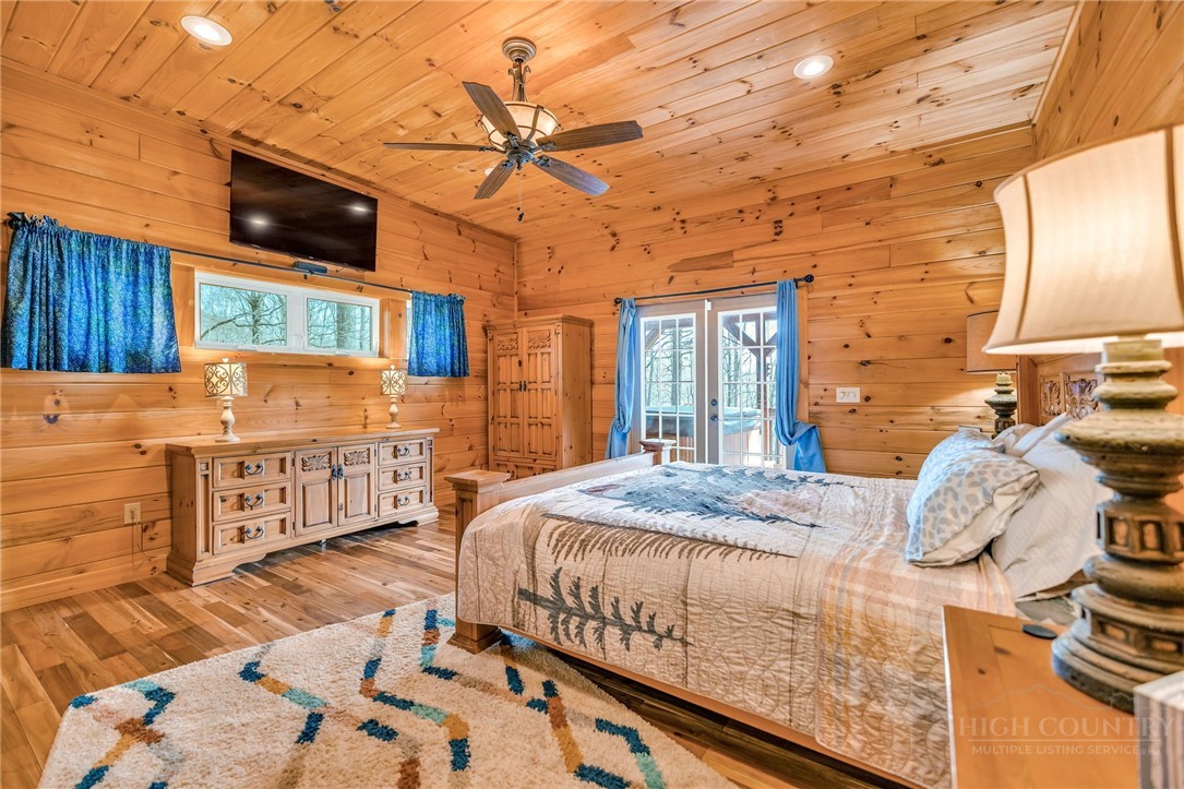 7994 3 Top Road Todd, NC 28684 - Photo 17 of 50 a bed sitting in a bedroom next to a window