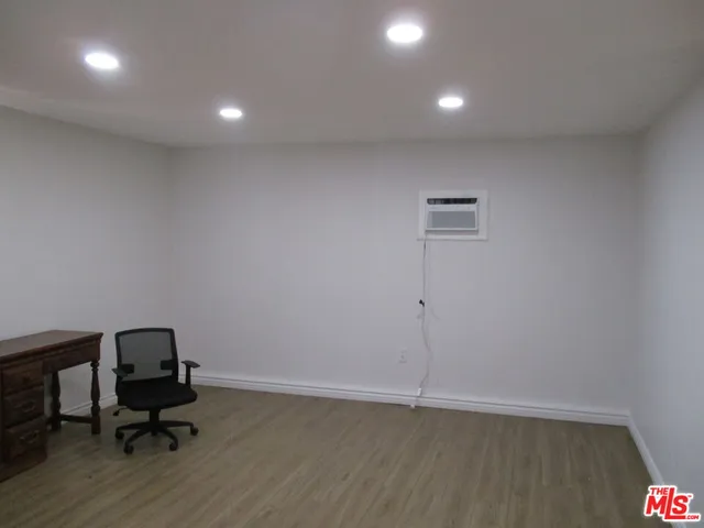 a view of workspace with wooden floor and lounge chair