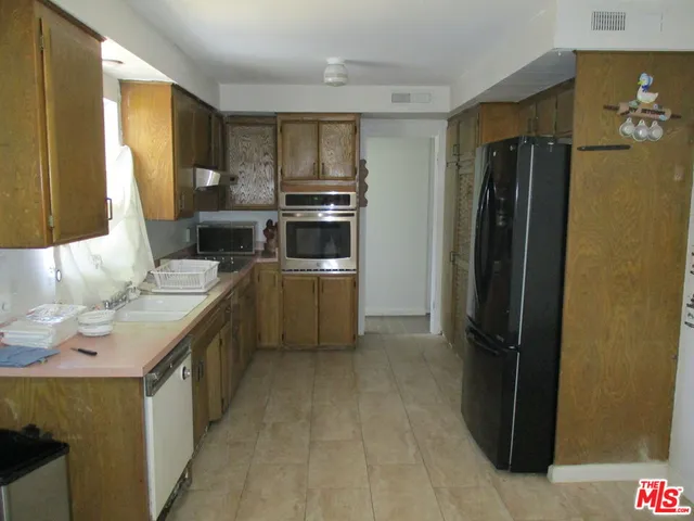 a kitchen with a refrigerator and a sink