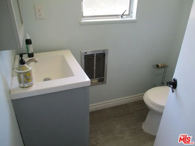 a bathroom with a sink a toilet and mirror