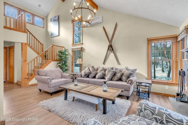 a living room with furniture a rug and a chandelier