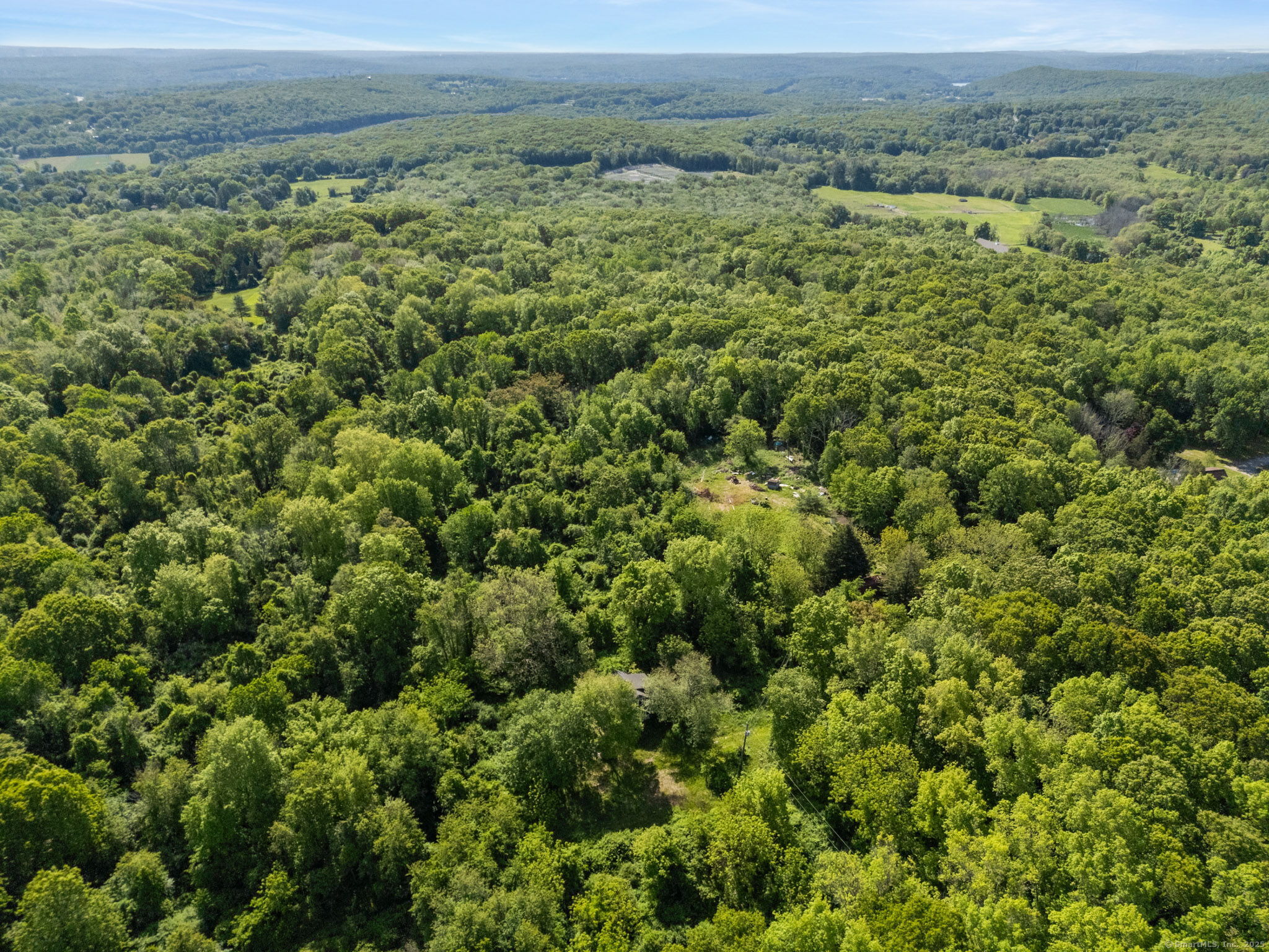 63 Velgouse Road Montville, CT 06370 - Photo 19 of 21 an aerial view of a houses with a lush green hillside