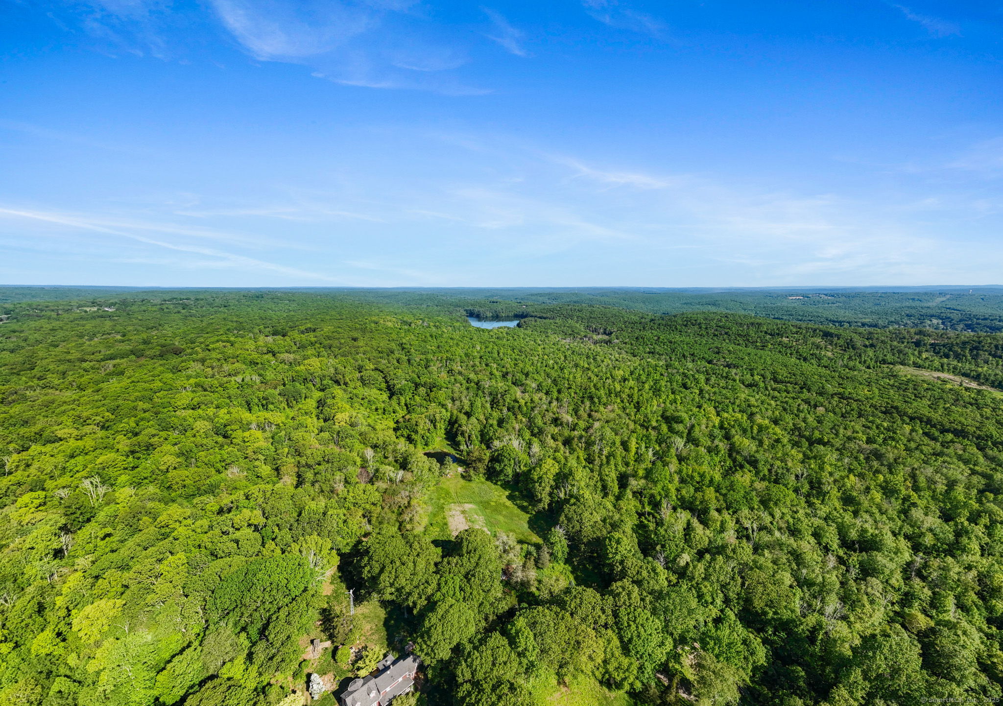 63 Velgouse Road Montville, CT 06370 - Photo 4 of 21 a view of a green field with lots of bushes