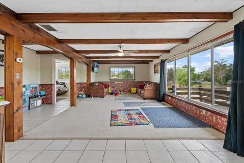 a living room with furniture and a floor to ceiling window