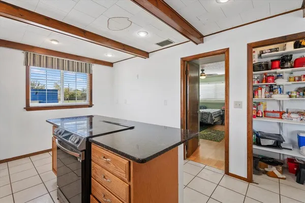 a kitchen with stainless steel appliances granite countertop a sink dishwasher and stove with wooden floor