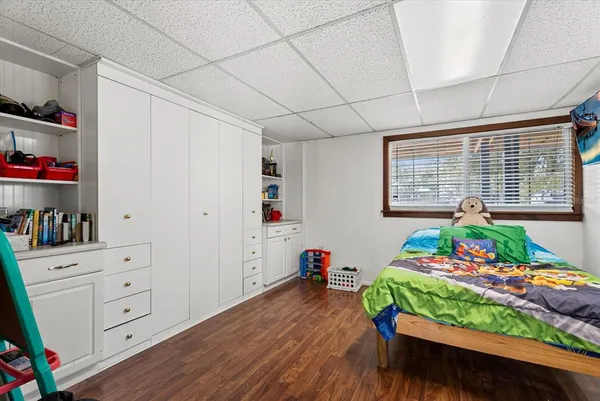 a living room with furniture a flat screen tv and a floor to ceiling window