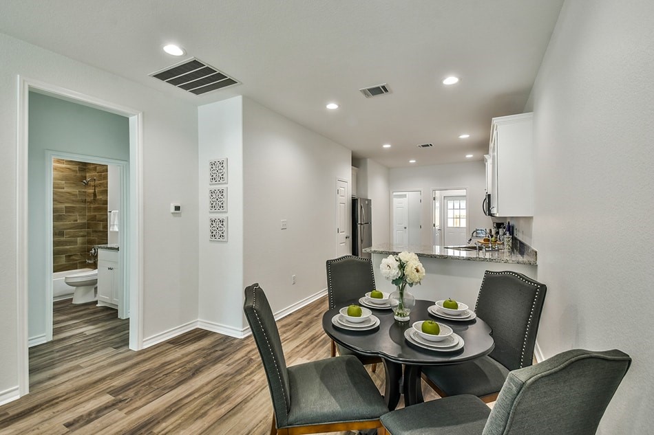 24094 Sears Lane, Unit 13 Porter, TX 77365 - Photo 7 of 11 a view of a dining room with furniture and wooden floor