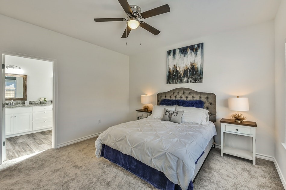 24094 Sears Lane, Unit 13 Porter, TX 77365 - Photo 8 of 11 a bedroom with a large bed and a chandelier fan