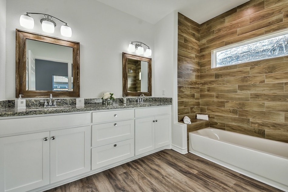 24094 Sears Lane, Unit 13 Porter, TX 77365 - Photo 9 of 11 a bathroom with double vanity sink a mirror a bathtub and